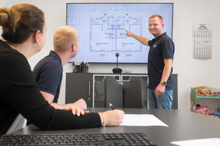 Der Personen besprechen in einem Meeting einen Bauplan